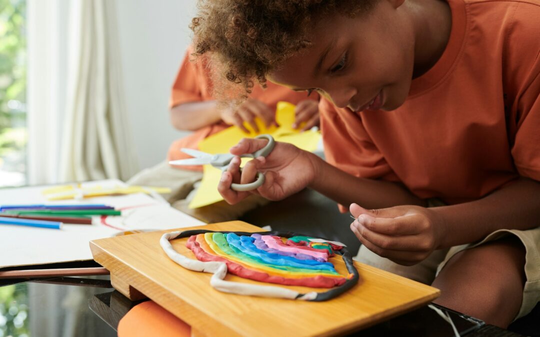 Creative kid making rainbow out of